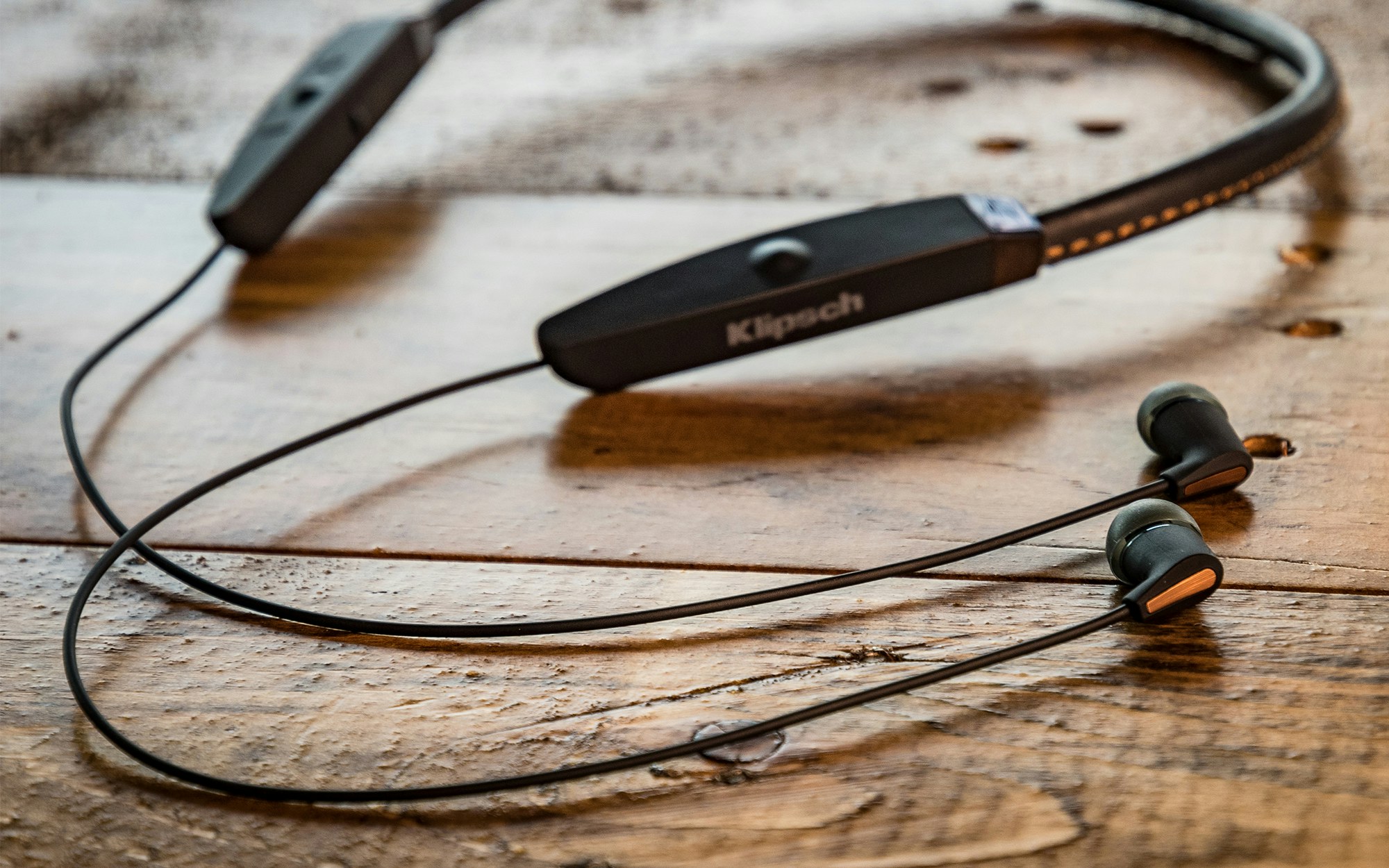 R5 Neckband on a wooden table